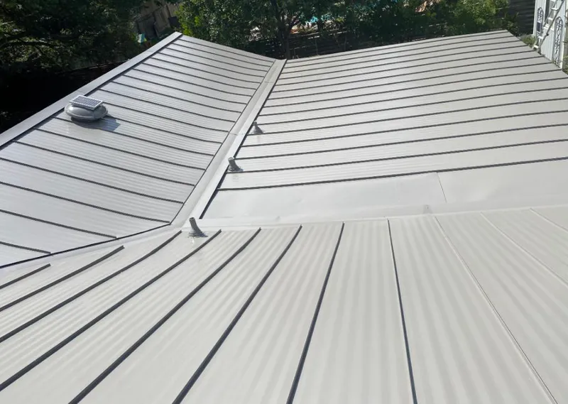 Solar attic fan installed on a metal roof for Roof Ventilation in DeForest
